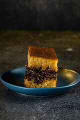 Kue Hok Lo Pan or martabak bangka. The martabak bangka batter is made from a mixture of flour, eggs, sugar, baking soda, coconut milk and water.The batter is cooked upon a thick round iron frying pan 