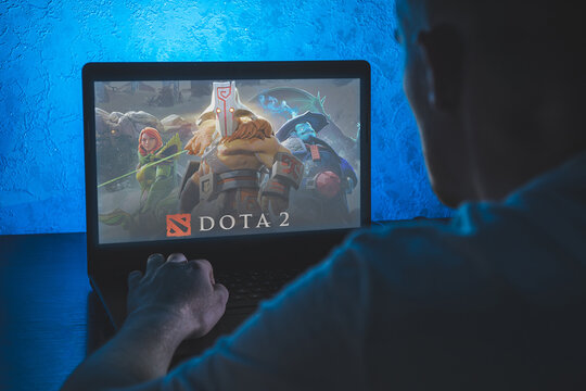 Dota 2 is a multiplayer online battle arena video game. Video computer game. Man play video game on laptop