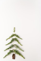 Winter concept. Pine branches in a form of pine tree. Christmas, winter, holiday season. Minimal composition with copy space.