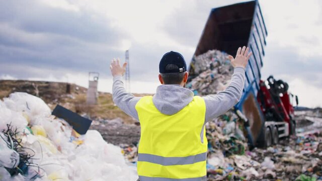 videoblocks a rear view of worker on landfill waste management and environmental concept