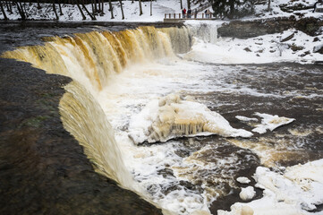 Partly frozen Keila-Joa waterfall in winter