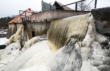 Partly frozen Keila-Joa waterfall in winter