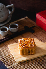 Mooncake as Chinese pastry on wooden background, season to cerebrate Mid-Autumn Festival