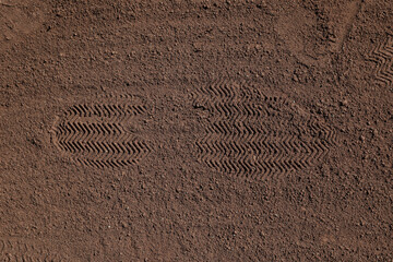 Textured ground surface with footprint, top view