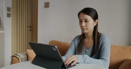Woman work on tablet computer at home
