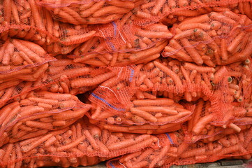 A heap of carrots in carry bags on a market in Berlin-Germany.