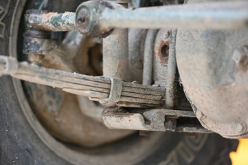 The dirty leaf springs of an old off-road vehicle.