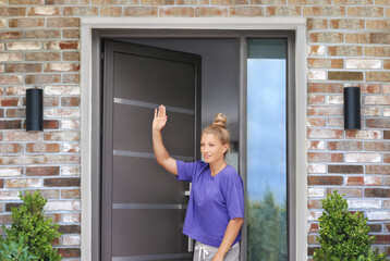 Beautiful woman opening the door of her home.