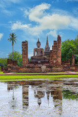 Fototapeta na wymiar Ancient Buddha Statue at Sukhothai historical park, UNESCO World Heritage Site in Thailand