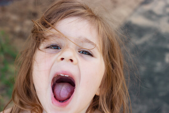 Portrait of cute baby girl with open mouth