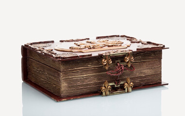 Wooden box stylized as an old book on a white table