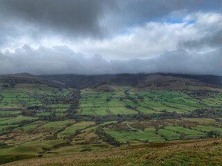 Obraz premium Aerial view of English countryside with green fields and dramatic cloudy sky. 