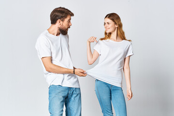 Fototapeta premium cheerful young couple in white t-shirts design fashion fun Copy Space