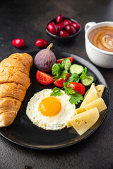 breakfast fried eggs and a cup of coffee liquid egg yolk fresh portion ready to eat meal snack on the table copy space food background rustic. top view keto or paleo diet veggie or vegetarian