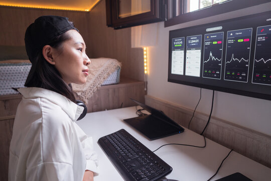 Serious ethnic female trader analyzing cryptocurrency market statistics