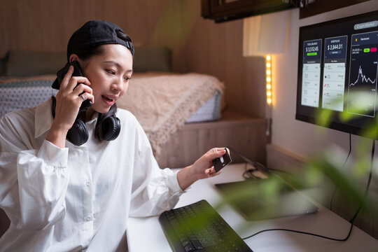 Amazed ethnic woman having phone during remote work with cryptocurrency