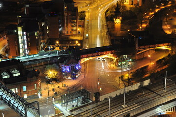 Fototapeta na wymiar Aerial view of a city street at night with light trails from moving traffic. Taken in Manchester City centre. 