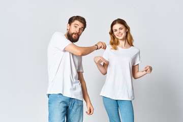 man and woman in white t-shirts studio fashion posing