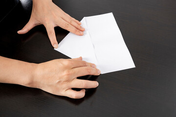 Obraz premium A woman is folding paper.