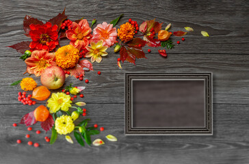 Vintage photo frame with natural autumn orange flowers leaves and pumpkins on a dark wooden background with raindrops. Place for your text or photos. Autumn holiday concept. Postcard, congratulations
