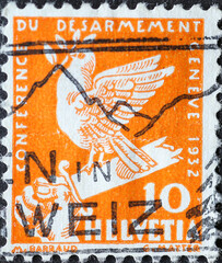 Switzerland - Circa 1932: a postage stamp printed in the Switzerland showing a dove of peace on a broken sword for the disarmament conference in Geneva, Switzerland