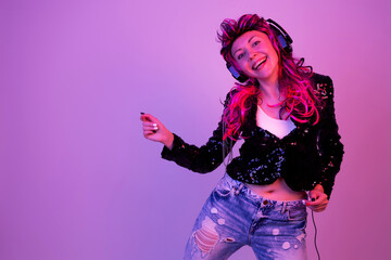 The girl listens to music with headphones.