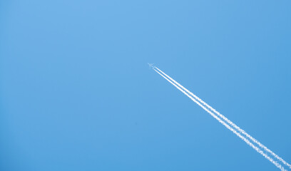 airplane flying high in the blue sky