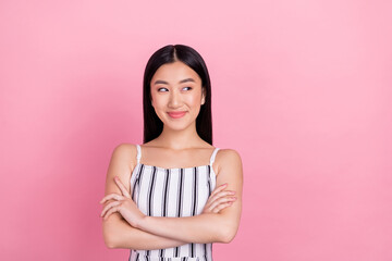 Photo of shiny dreamy young lady wear striped outfit smiling arms crossed looking empty space isolated pink color background