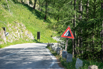 Road sign falling stones. Traffic sign caution possible falling rocks