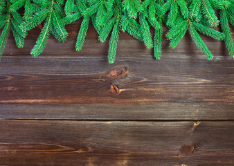 Fir branches on wooden rustic planks. Christmas background. High angle view.