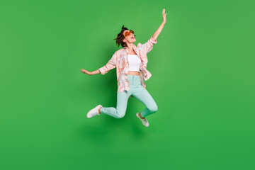 Fototapeta na wymiar Full body photo of cheerful joyful happy woman jump up wear summer sunglass look empty space isolated on green color background