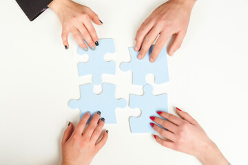 Business people hold in hand a jigsaw puzzle. Business solutions, success and strategy concept.