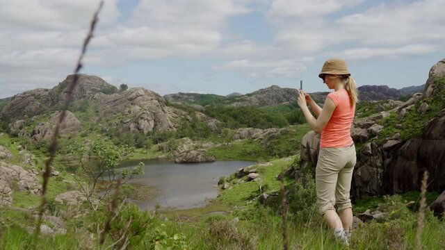 Female Hiker Photographing Beautiful Landscape With Phone