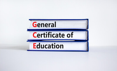 GCE, general certificate of education symbol. Words GCE, general certificate of education on books on a beautiful white background. Education, general certificate of education concept. Copy space.