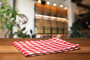 Napkin and board for pizza on wooden desk. Stack of colorful dish towels on white wooden table...