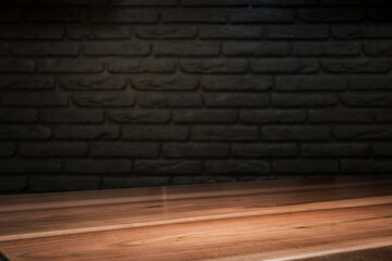 Selected focus empty brown wooden table and wall texture or old black brick wall blur background image. for your photomontage or product display