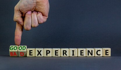 Good or bad experience symbol. Businessman turns wooden cubes, changes words bad experience to good experience. Beautiful grey background, copy space. Business, good or bad experience concept.