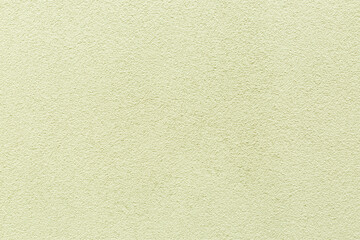 Obraz premium Sample of a texture of olive plaster. Wall finished with a decorative cement stucco. Example of exterior building decoration. Clean uniform grainy background. Banner. Wallpaper. Copy space. Pattern