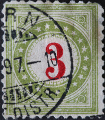 Switzerland - Circa 1878: a postage stamp printed in the Switzerland showing a circle with stars and a number in the middle. Postage only for non-profit institutions. No 3