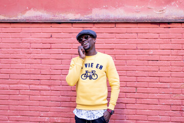 African funny man consults mobile phone