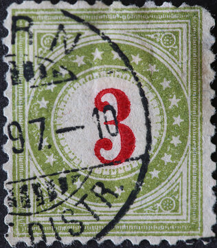 Switzerland - Circa 1878: a postage stamp printed in the Switzerland showing a circle with stars and a number in the middle. Postage only for non-profit institutions. No 3