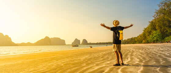 Wide panorama happy man traveler  joy fun on summer vacation at sunset Pak Meng beach, Leisure...