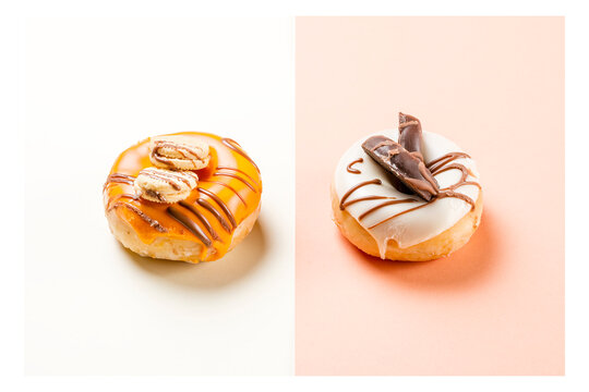 Photograph of two donuts decorated with cookies and drawn with chocolate.The photo is shot in horizontal format and has a white frame around it