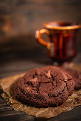 Fresh chocolate cookies on a wooden background