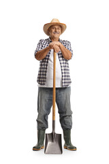 Full length portrait of a mature farmer leaning on a shovel and smiling - obrazy, fototapety, plakaty