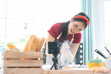 woman blogger making a bread, and recording stream live video online from camera