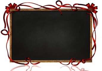 Blank black chalkboard with red bow. For greetings for Christmas or a birthday