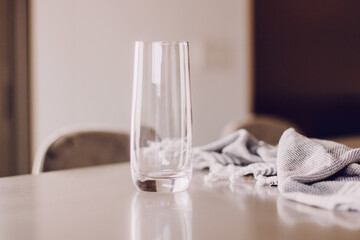 Transparent high glass on kitchen table. Natural day light.
