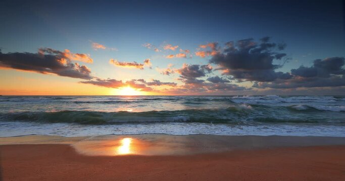 Beach sunrise over the tropical sea waves and exotic shore