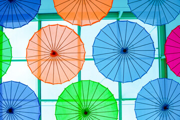 Colorful umbrellas hung from the ceiling in a shopping mall